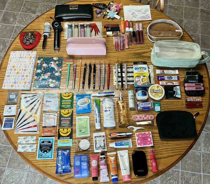 Various neatly arranged personal items on a wooden table illustrating satisfying organization and knolled order.