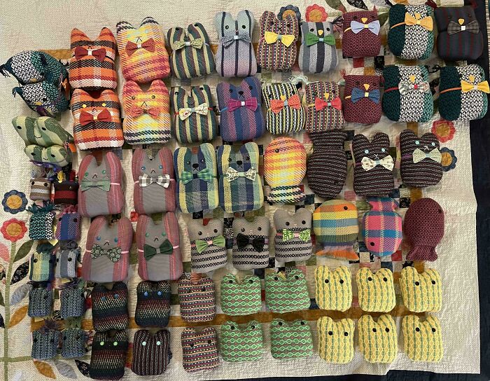 Neatly arranged colorful knolled fabric animals in rows, showcasing order and soothing patterns.