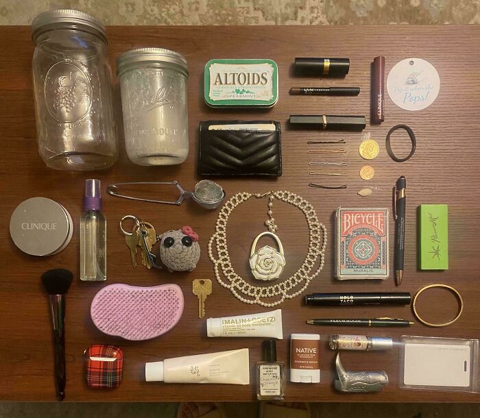 Neatly arranged personal items including jars, cosmetics, jewelry, keys, and cards showcasing all things knolled for order.