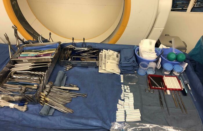 Surgical instruments and medical supplies neatly arranged on a blue cloth, demonstrating all things knolled order and organization.