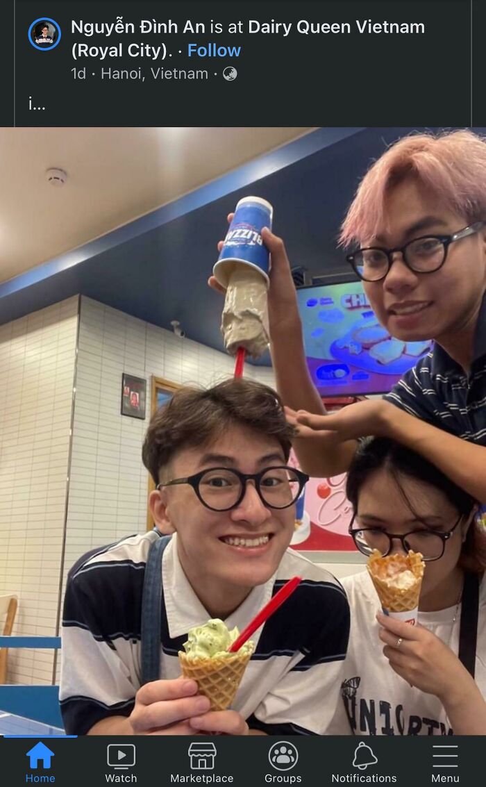 Three friends enjoying ice cream at Dairy Queen with one pouring a frozen treat upside down, capturing a frozen frames moment.