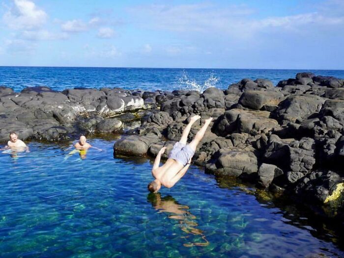 Man mid-flip diving into natural pool surrounded by rocks, capturing one of the 84 frozen frames showing action before aftermath.