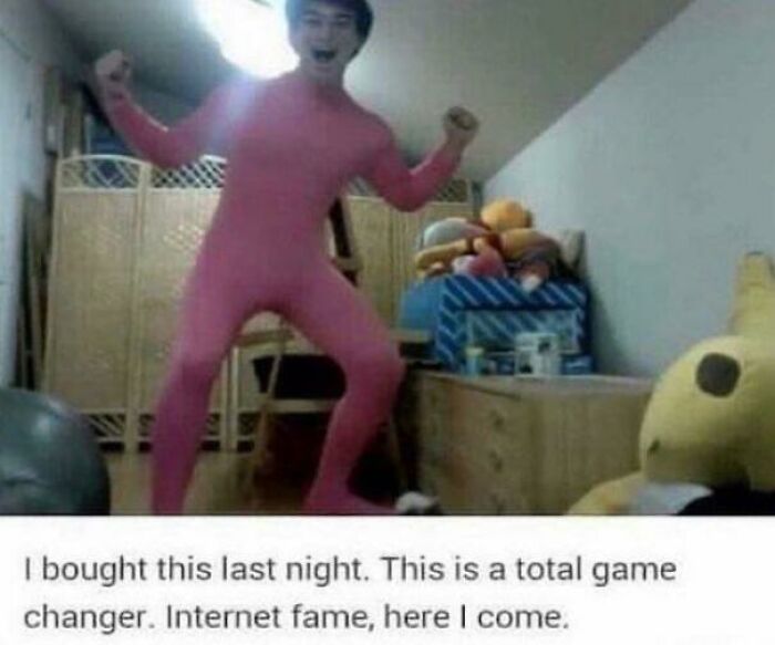 Person in full pink suit striking a pose indoors, capturing a frozen frame that tells everything without showing aftermath.