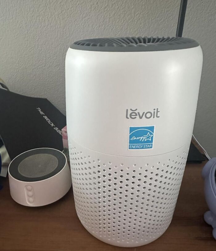Levoit air purifier on a wooden table, showcasing a compact design with Energy Star label for 11.11 deals.
