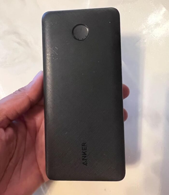Hand holding a black Anker portable charger, showcasing one of the best 11.11 deals for lucky shoppers.