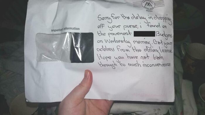 Handwritten note on envelope showing stranger returned lost purse, restoring faith in humanity with kindness.