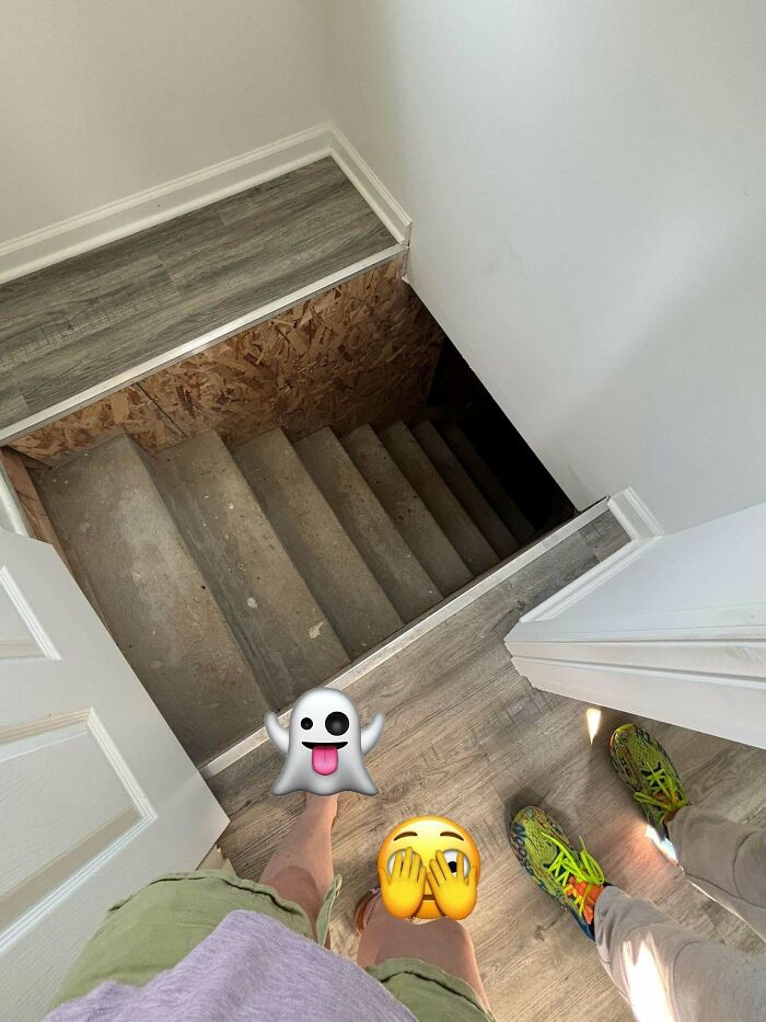 View down a steep, unfinished staircase in an Airbnb rental, emphasizing the need for insurance and caution.
