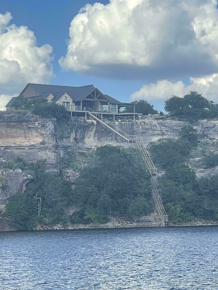 House on a cliff with an extremely long staircase descending 130 stairs, highlighting Airbnb insanity and insurance necessity.