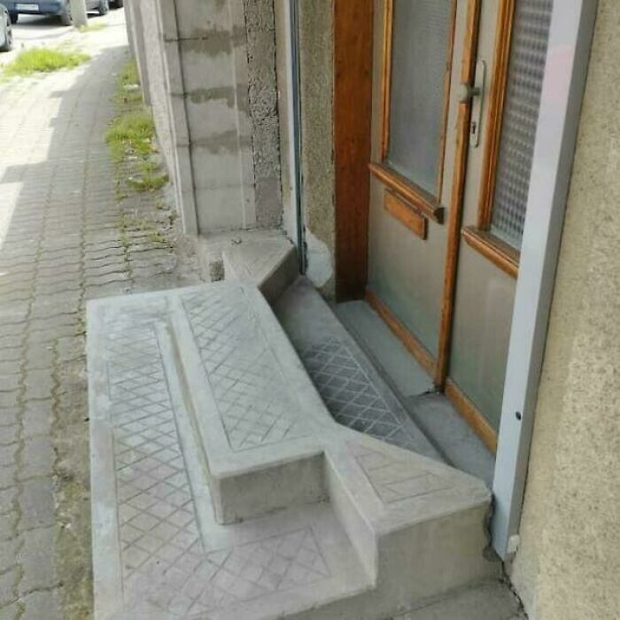 Concrete stairs with an unusual layout posing a challenge for Airbnb guests, emphasizing the need for insurance and safety precautions.