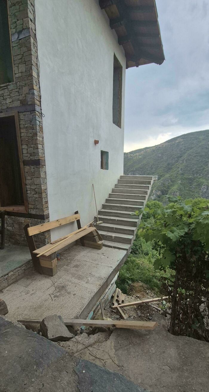 Steep outdoor stairs leading off a building with no railing overlooking a steep drop, illustrating Airbnb insurance risks.