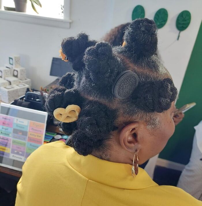 Woman with novelty hair accessories shaped like cookies and pretzels, showcasing completely unnecessary novelty finds hairstyle ideas.