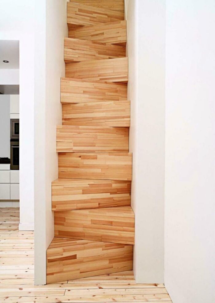 Unique wooden stairs with irregular shapes and angles inside a modern Airbnb rental needing insurance for safety concerns.