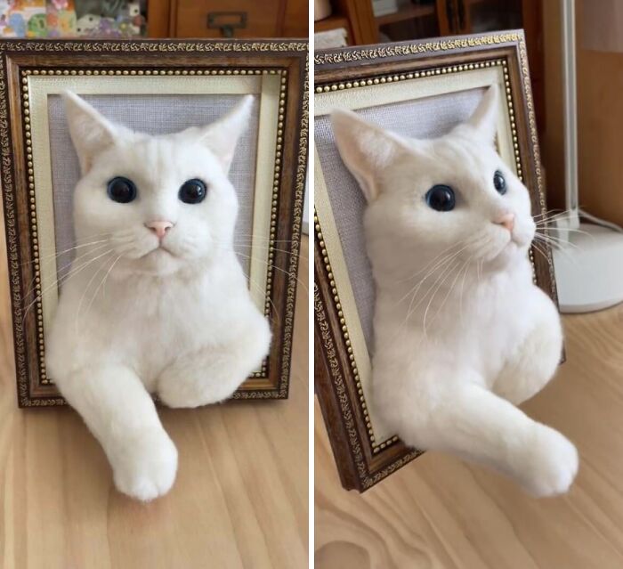 3D white cat sculpture by creative people, emerging from a framed canvas as a cool artistic project.