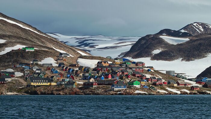 Colorful houses in a remote snowy location near water, showcasing one of the mind-blowing remote locations that actually exist.