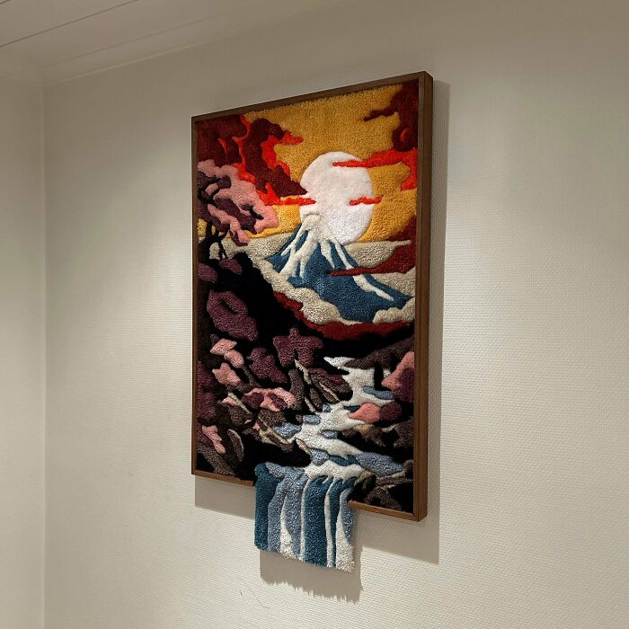 Tactile art piece of a mountain landscape with a waterfall, showcasing creative people’s cool projects in a unique style.