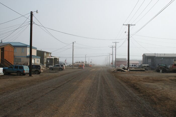 Remote dusty road in a small foggy town showcasing one of the mind-blowing remote locations that actually exist.
