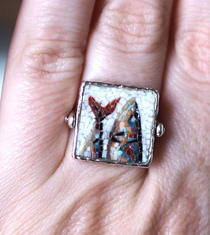Close-up of a hand wearing a square mosaic ring showcasing creative art in a unique cool project design.