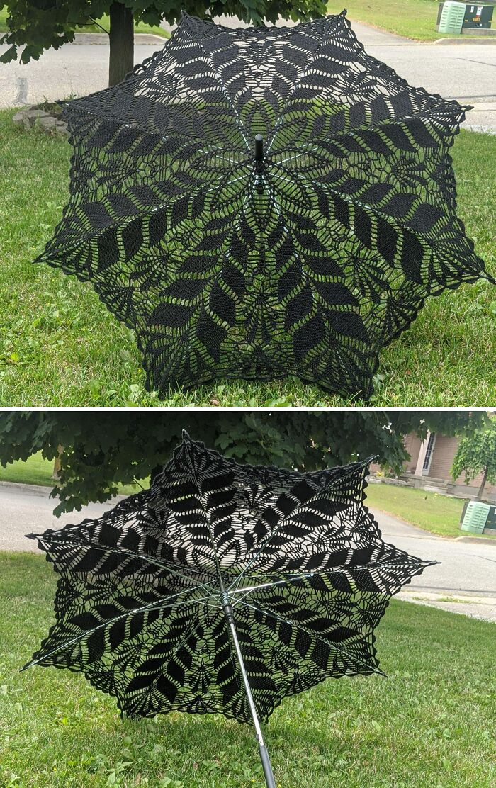 Black lace umbrella with intricate leaf patterns displayed outdoors on grass, showcasing creative people’s cool projects.