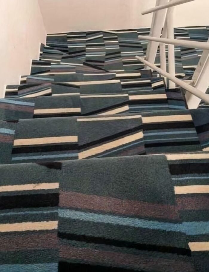 Carpeted stairs with a confusing pattern creating an optical illusion, illustrating Airbnb insanity risk factor.