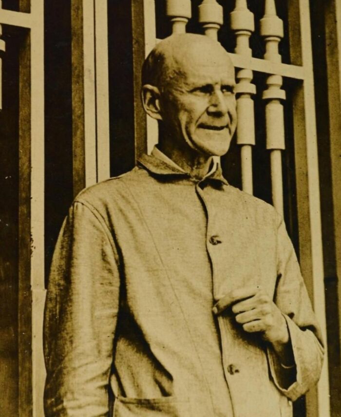 Sepia-toned photo of a man in vintage clothing standing by a barred window, illustrating hilarious historical events.