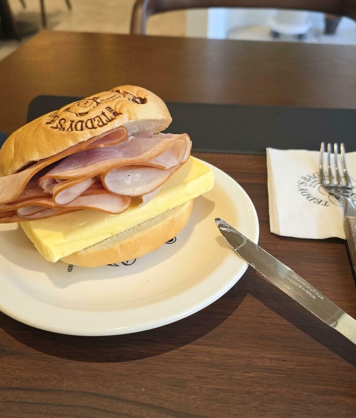 Ham and thick slice of butter sandwich on a white plate, illustrating one of the dishes that are just stupid.