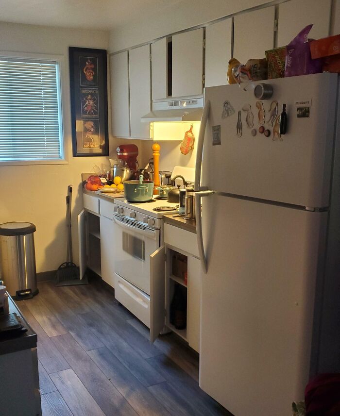 Cluttered kitchen scene with open cabinets and stove, illustrating a petty revenge prank in a home setting.
