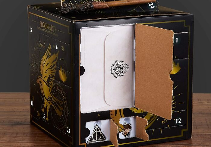 Hogwarts-themed advent calendar with numbered compartments and festive designs for Christmas countdown celebration.