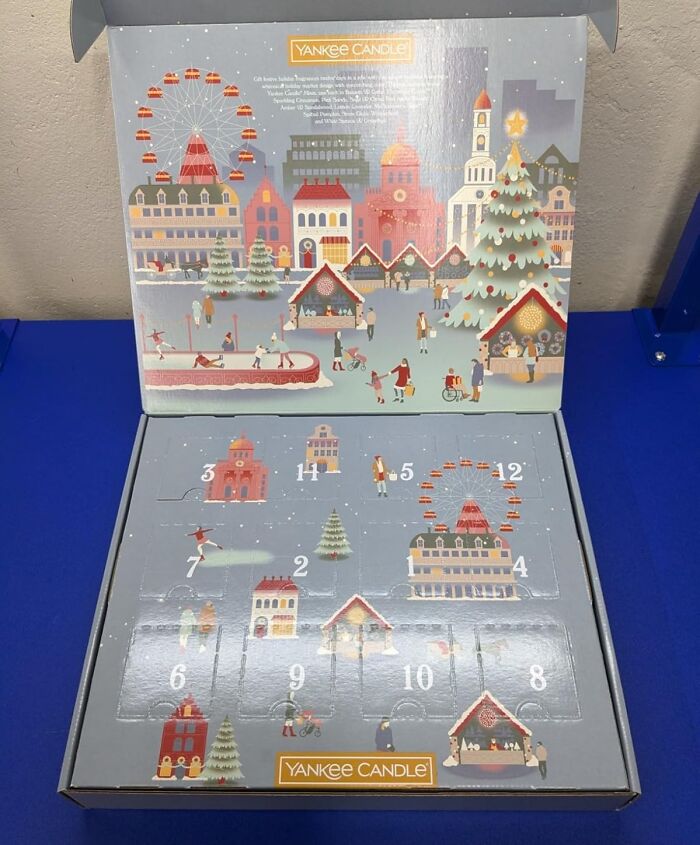 Yankee Candle advent calendar with festive winter village and numbered doors for holiday countdown and Christmas joy.