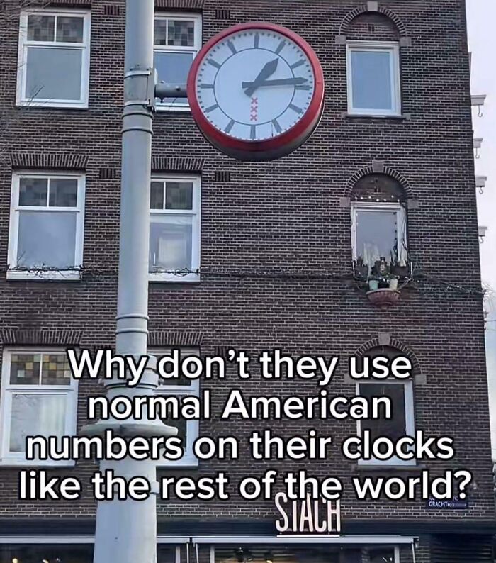 A brick building with a round clock showing incorrect numbers and a funny caption about American numbers on clocks.