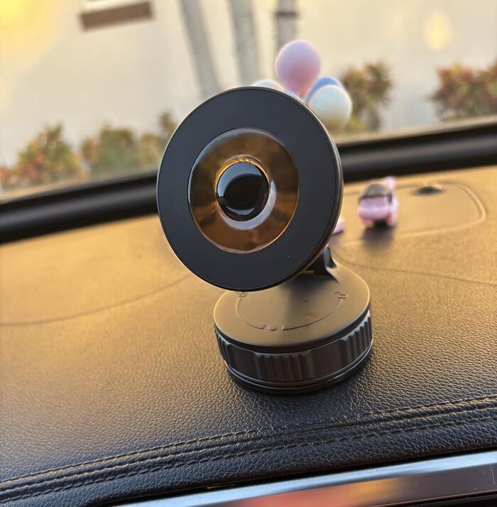  Your Phone's Days Of Face-Planting Onto The Car Floor Are Officially Over With This Magnetic Suction Phone Holder 