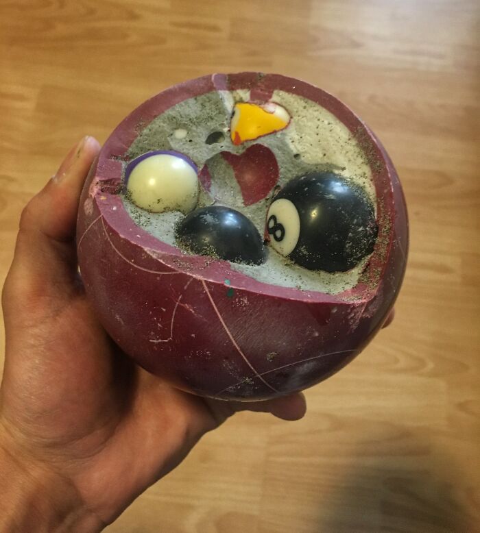 Cross-section of a bowling ball showing the intricate insides of the object with embedded smaller balls inside.