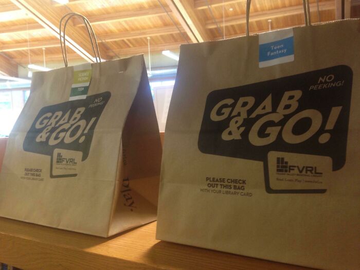 Two brown paper bags labeled Grab & Go on a wooden table, showcasing smart ideas and inventions that solve a problem.