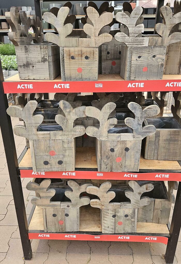 Wooden planters with reindeer faces and antlers, showing funny examples of people not even trying in decoration.