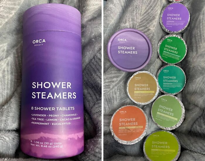 Purple ORCA Beauty Shower Steamers package and individual shower tablets arranged on a soft blanket, ideal for burr basket goodies.
