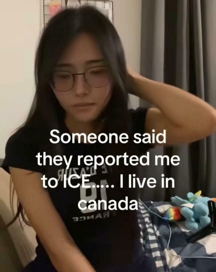 Young woman wearing glasses sitting in a room with a caption about living in Canada, highlighting Canada roasted America humor.