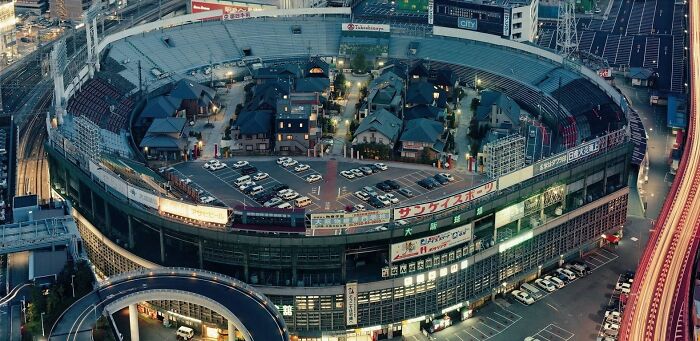 Aerial view of a stadium transformed into a residential area, showcasing a world from a completely different perspective.