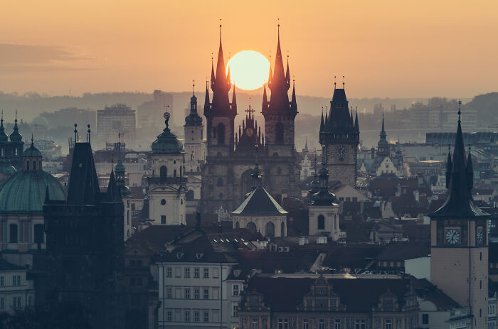 Sunset behind gothic church spires in a cityscape, showing our world from a unique and amazing perspective.