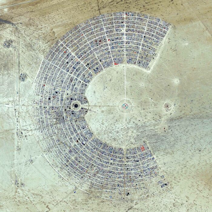 Aerial view of a large circular desert settlement showcasing our world from a completely different perspective.