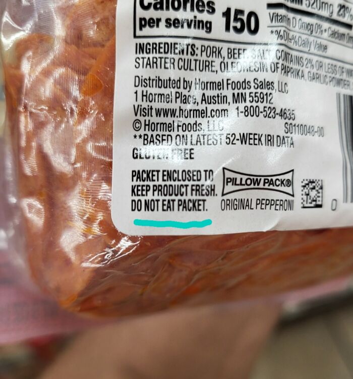 Close-up of a pepperoni package label with a warning not to eat the enclosed packet, showcasing zero common sense.