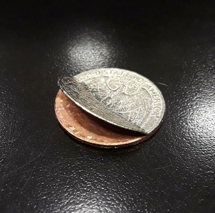 Close-up of a split coin revealing the unusual inside structure of a common object you might not have known.