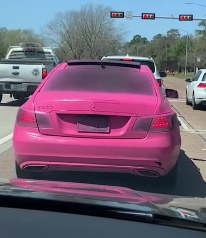 Pink Mercedes with tinted windows and obscured license plate, demonstrating a funny example of people not even trying.
