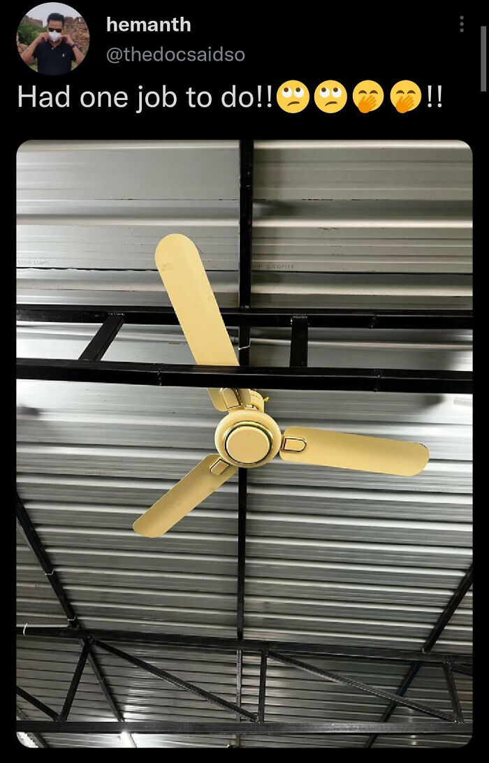 Ceiling fan with one blade installed upside down, a funny example of people not even trying in job completion.