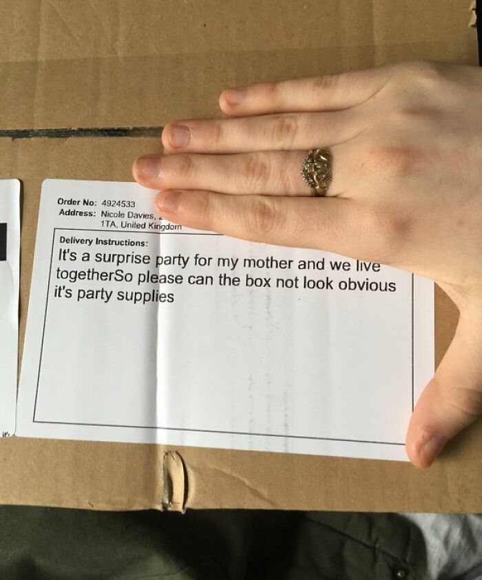Hand covering address on a package with delivery instructions showing a funny example of not trying with party supplies request.