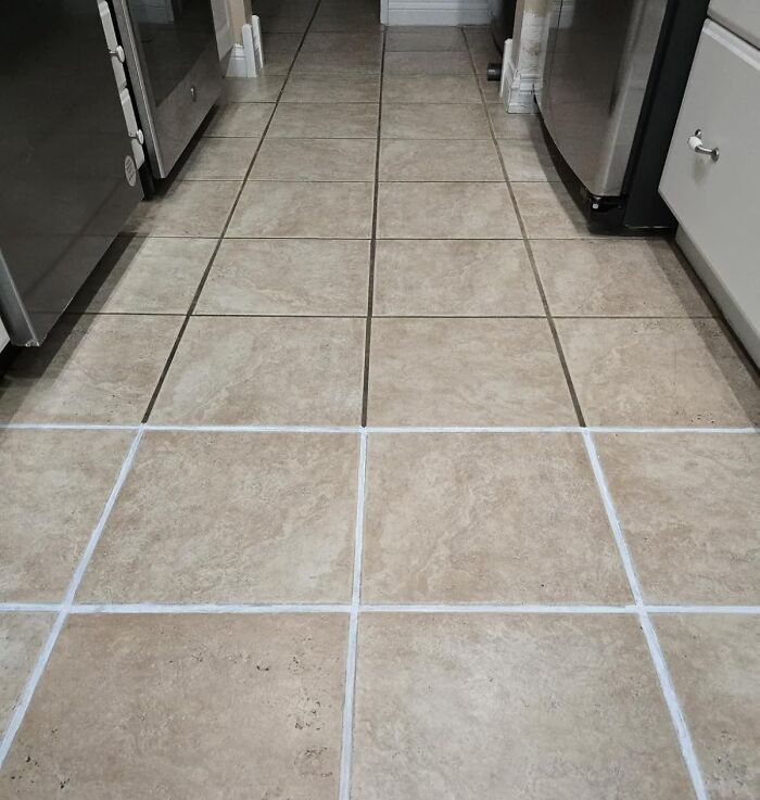 Freshly cleaned and sealed tile grout in a kitchen, helping ensure full security deposit return from landlord.
