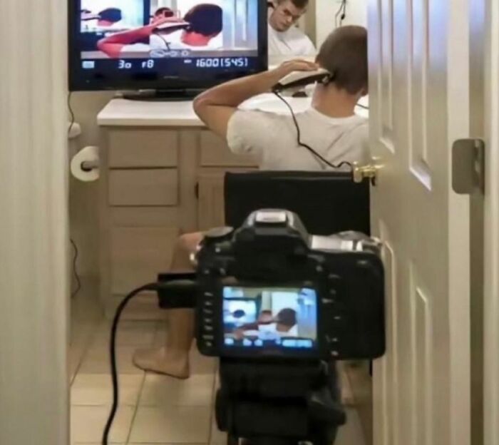 Young adult filming a creative scene in a bathroom, showcasing relatable student life and interesting moments.