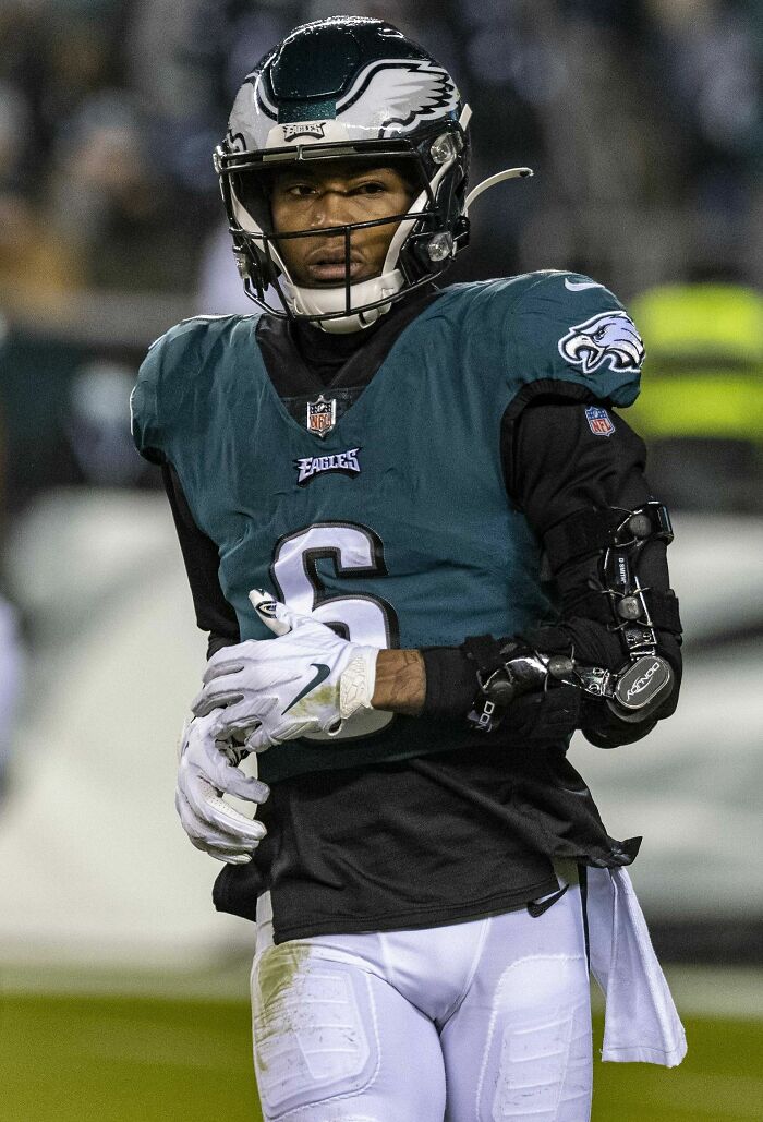 American football player wearing Philadelphia Eagles uniform and helmet during a game, highlighting DeVonta Smith career.