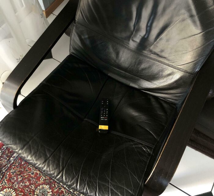 Black leather armchair with a TV remote placed on the seat showcasing smart ideas and inventions solving everyday problems.