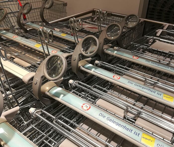 Close-up of shopping carts with attached magnifying glasses as a smart idea and invention that solves a problem.