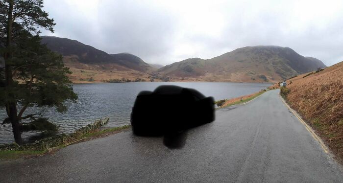 Scenic lakeside road with mountains under cloudy sky, illustrating a popular where was this taken internet post.