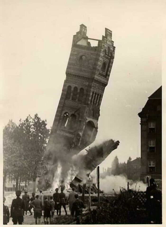 Old tower collapsing in a black and white photo with onlookers, featured in where was this taken posts online.